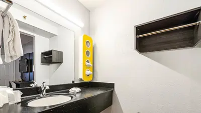 a bathroom with a sink and a mirror at Motel 6-Wethersfield, CT - Hartford in Wethersfield