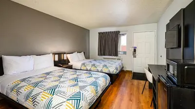 a hotel room with two beds and a television at Motel 6-Wethersfield, CT - Hartford in Wethersfield