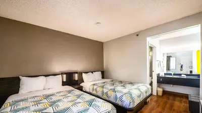 a hotel room with two beds and a sink at Motel 6-Wethersfield, CT - Hartford in Wethersfield