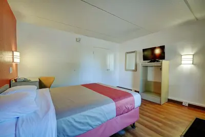 a hotel room with a bed and a television at Motel 6-Chicopee, MA - Springfield in Chicopee