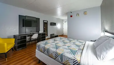 a bedroom with a bed and a desk and a television at Motel 6-Branford, CT - New Haven in Branford