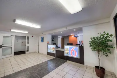 a waiting room with a potted plant in a building at Motel 6-Branford, CT - New Haven in Branford