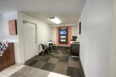 a hallway with a waiting room with a table and chairs at Motel 6-Branford, CT - New Haven in Branford