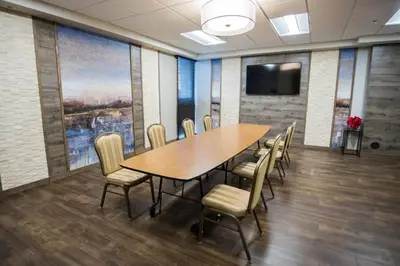a conference room with a wooden table and chairs at Holiday Inn Newark International Airport in Newark