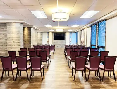 a conference room with chairs and a podium in the middle at Holiday Inn Newark International Airport in Newark