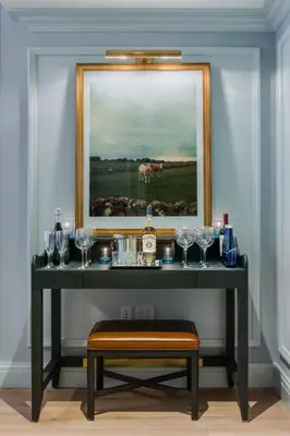a table with glasses and a picture on the wall at Merrion Row Hotel and Public House in New York