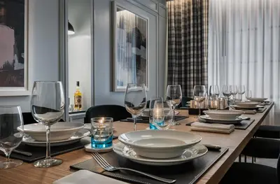 a dining room table with glasses and plates on it at Merrion Row Hotel and Public House in New York