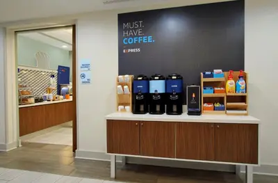 a coffee shop with a counter with bottles of coffee at Holiday Inn Express and Suites Stroudsburg-Poconos by IHG in Stroudsburg