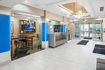 a large lobby with a desk and a television at Holiday Inn Express and Suites Stroudsburg-Poconos by IHG in Stroudsburg