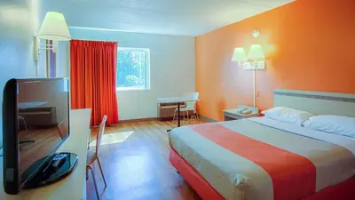 a hotel room with a bed and a flat screen tv at MOTEL 6 - Albany, NY - Airport in Albany