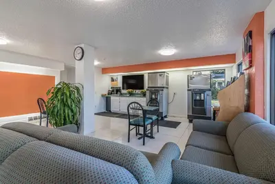 a living room with a couch and a kitchen at MOTEL 6 - Albany, NY - Airport in Albany