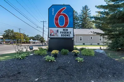 a sign for a new privacy house with plants at MOTEL 6 - Albany, NY - Airport in Albany