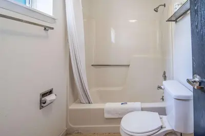 a bathroom with a toilet and a bath tub at MOTEL 6 - Albany, NY - Airport in Albany