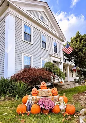 a group of pumpkins in front of a house at Maple Terrace Motel in Williamstown
