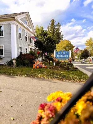 a house with a sign for a make pause sign at Maple Terrace Motel in Williamstown