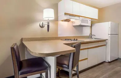 a small kitchen with a counter and a refrigerator at Extended Stay America Suites - Meadowlands - East Rutherford in East Rutherford