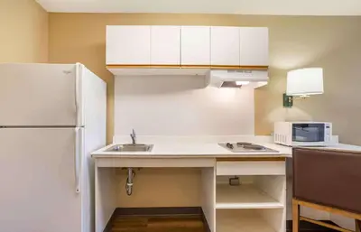 a kitchen with a white refrigerator and a sink at Extended Stay America Suites - Meadowlands - East Rutherford in East Rutherford
