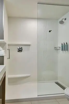 a shower with a glass door in a bathroom at Courtyard by Marriott Albany Troy/Waterfront in Troy