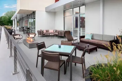 a patio with tables and chairs and a fireplace at Courtyard by Marriott Albany Troy/Waterfront in Troy