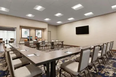 a conference room with a long table and chairs at Homewood Suites by Hilton Albany Crossgates Mall in Albany