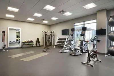 a gym with treadmills and exercise equipment in a room at Homewood Suites by Hilton Albany Crossgates Mall in Albany
