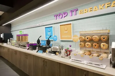 a bakery counter with donuts on top of it at Tru by Hilton Albany Crossgates Mall in Albany