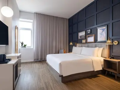 a hotel room with a bed and a television at voco Fiorello - LaGuardia Airport by IHG in Queens