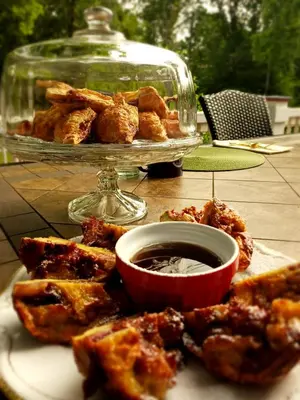 a plate of food with a bowl of dipping sauce at The Bevin House B&B in East Hampton