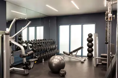 a gym with dumbbells and weights in a room at Hyatt Regency Greenwich in Greenwich