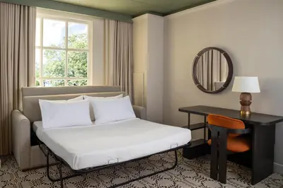 a hotel room with a bed and a mirror at Hyatt Regency Greenwich in Greenwich