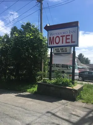a sign for a waterford inn motel on the side of the road at Waterford Inn in Waterford