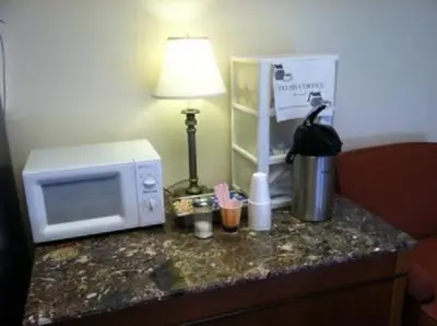 a kitchen counter with a microwave and a lamp on it at Waterford Inn in Waterford