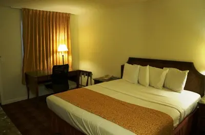 a hotel room with a bed and a desk at Waterford Inn in Waterford