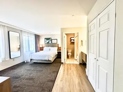 a bedroom with a bed and a bathroom at Staybridge Suites East Stroudsburg - Poconos by IHG in East Stroudsburg