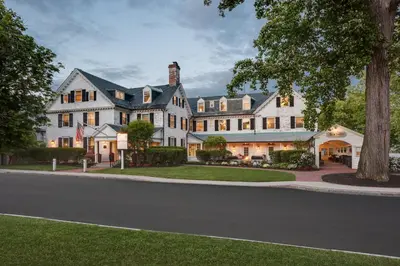 a large white house on a street at Inn on Boltwood in Amherst