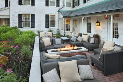a patio with couches and a fire pit at Inn on Boltwood in Amherst