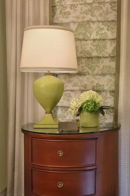 a lamp on top of a wooden table with flowers at Inn on Boltwood in Amherst