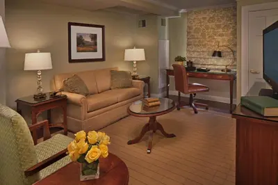 a living room with a couch and a table at Inn on Boltwood in Amherst