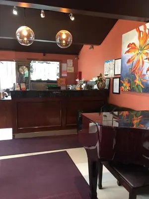 a dining room with a table and a counter at Motel 88 in Oneonta