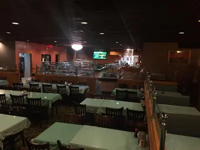 a restaurant with tables and chairs and a bar at Motel 88 in Oneonta