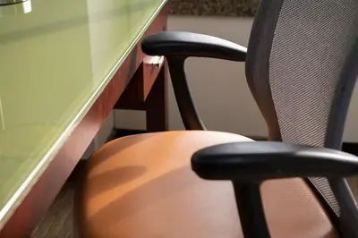 an office desk with two chairs next to a table at The Stamford Hotel in Stamford