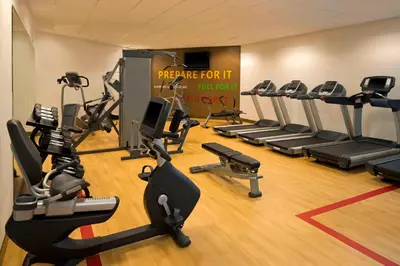 a gym with several treadmills and cardio machines at The Stamford Hotel in Stamford
