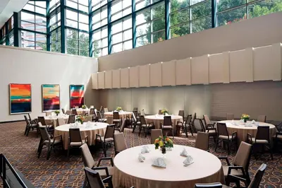 a dining room with tables and chairs and windows at The Stamford Hotel in Stamford