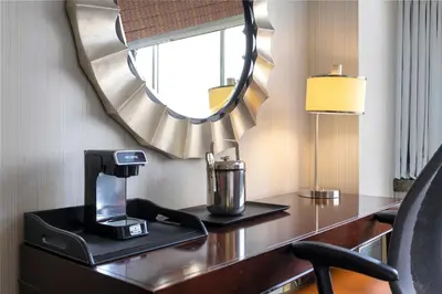 a desk with a coffee maker and a mirror at The Stamford Hotel in Stamford