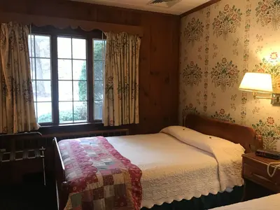 a bedroom with a bed and a window at The 1896 House Country Inn - Brookside & Pondside in Williamstown
