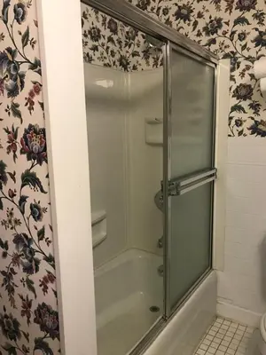 a shower with a glass door in a bathroom at The 1896 House Country Inn - Brookside & Pondside in Williamstown