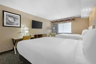 a hotel room with two beds and a television at Best Western Cooperstown in Cooperstown