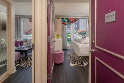 a hallway with purple walls and a room with a bed at Staypineapple, An Artful Hotel, Midtown New York in New York