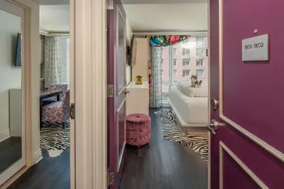 a bathroom with a purple door and a sink at Staypineapple, An Artful Hotel, Midtown New York in New York