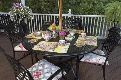 a black table with chairs and food on a deck at Beds on Clouds in Windham